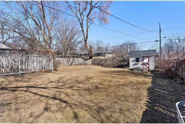 view of yard with a storage shed, an outdoor structure, and fence