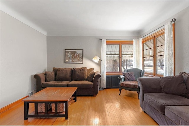 living area with light wood-style floors and baseboards