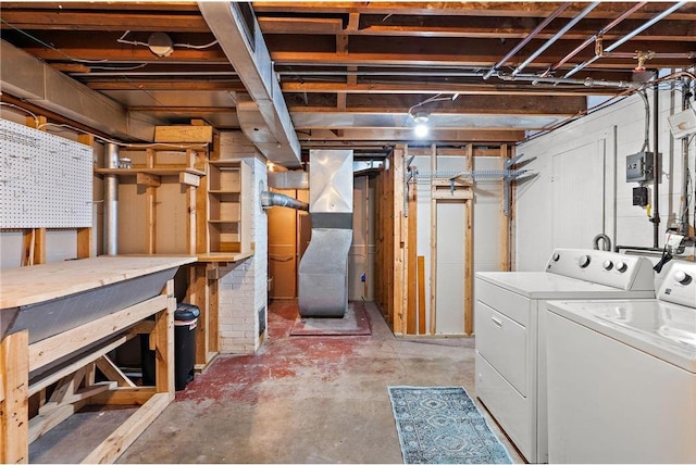 unfinished basement featuring washing machine and clothes dryer