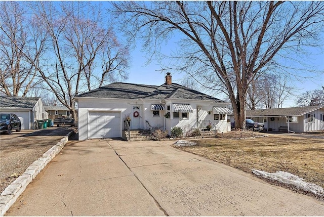 view of front of house with a garage, concrete driveway, a chimney, and stucco siding