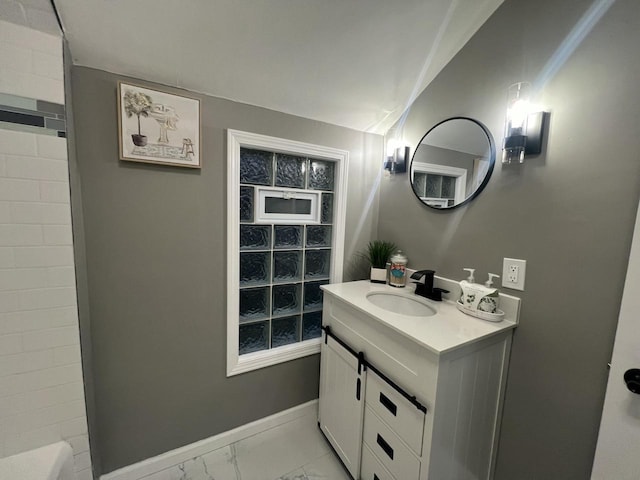 full bath with marble finish floor, vanity, and baseboards