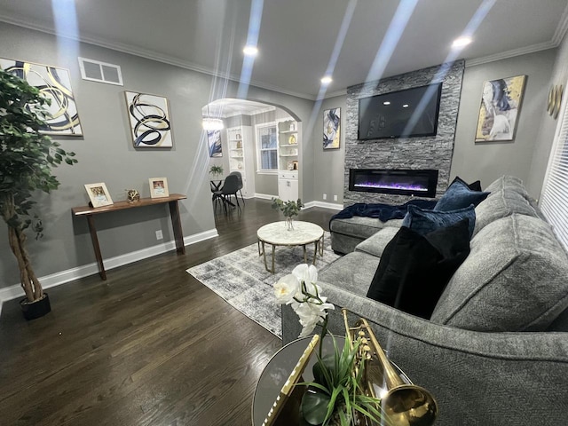 living room featuring arched walkways, wood finished floors, visible vents, baseboards, and crown molding