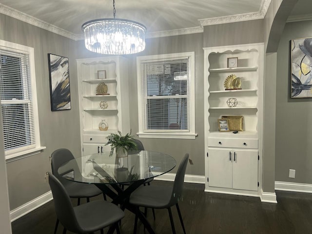 dining room with ornamental molding, a chandelier, dark wood finished floors, and baseboards