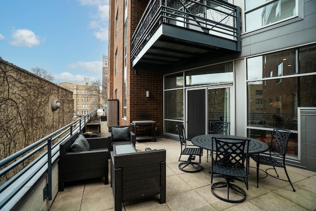 view of patio / terrace with an outdoor living space and a balcony