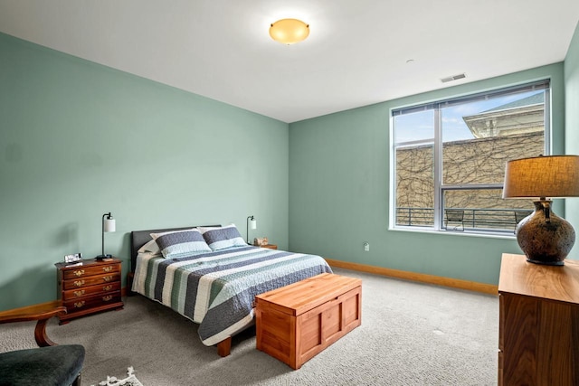 carpeted bedroom featuring baseboards and visible vents