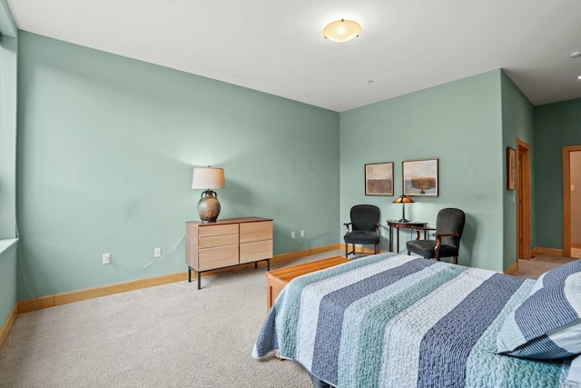 bedroom featuring carpet and baseboards