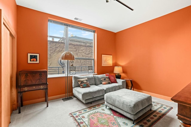 living room with light carpet, baseboards, and visible vents