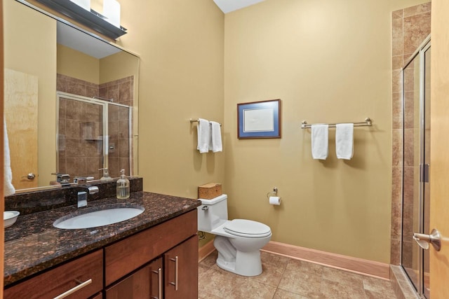 full bathroom with baseboards, toilet, tile patterned flooring, vanity, and a shower stall