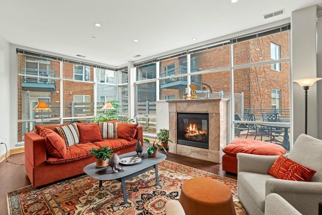 sunroom with visible vents and a fireplace