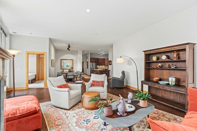 living area featuring wood finished floors and baseboards