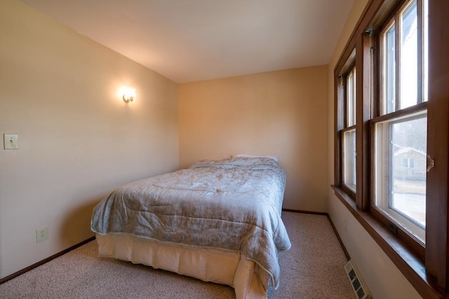 bedroom with carpet floors, baseboards, and visible vents