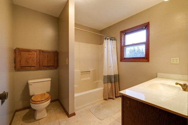 bathroom featuring baseboards, vanity, toilet, and tile patterned floors