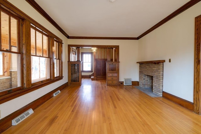 unfurnished living room featuring light wood finished floors, a fireplace, visible vents, and baseboards