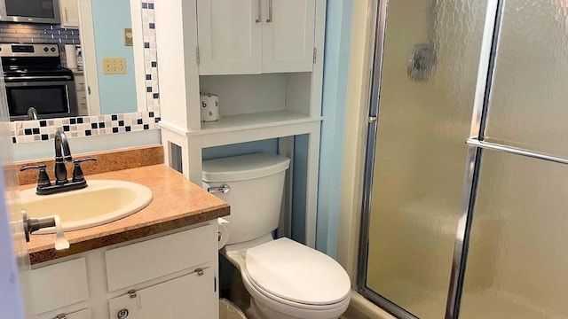 full bathroom featuring toilet, a shower stall, decorative backsplash, and vanity