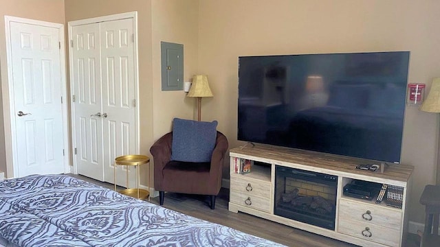 bedroom featuring electric panel and wood finished floors