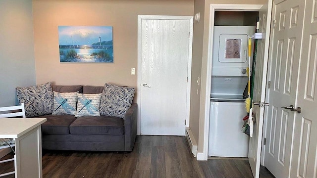 living area with stacked washing maching and dryer and dark wood-style floors