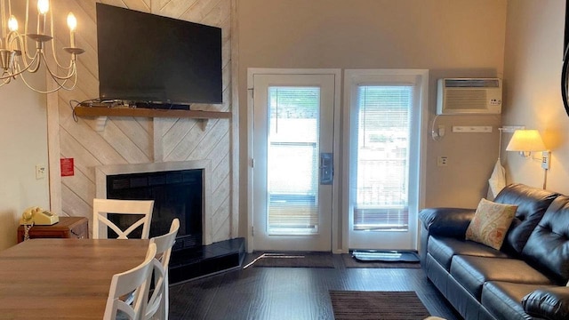 living area featuring dark wood finished floors, plenty of natural light, a premium fireplace, and a wall mounted AC