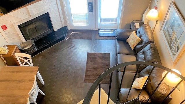 living area with a fireplace and wood finished floors