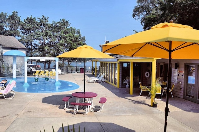 community pool featuring a patio area and fence