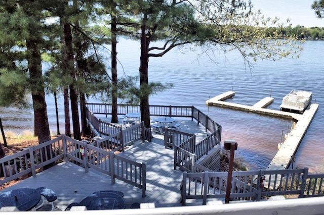 view of dock featuring stairs and a water view