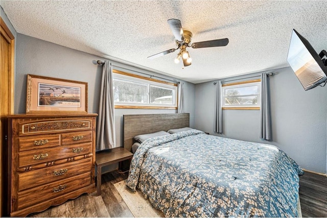 bedroom with ceiling fan, a textured ceiling, and wood finished floors