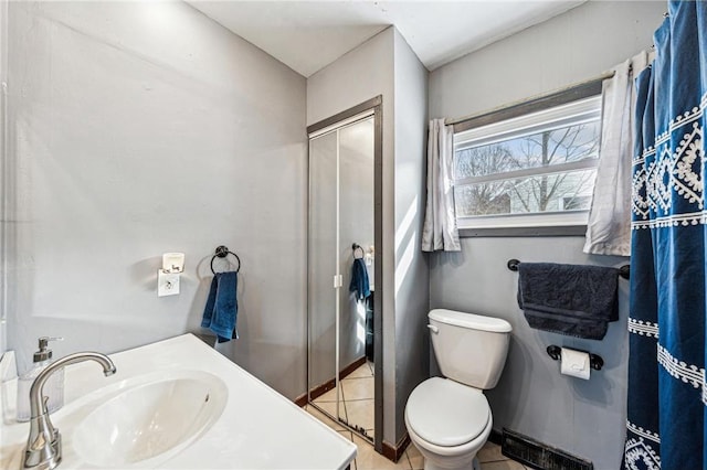 full bath featuring toilet, a shower stall, vanity, and tile patterned floors