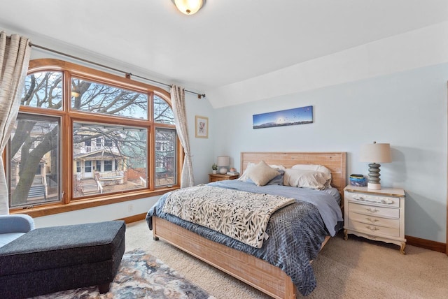 bedroom featuring carpet floors, lofted ceiling, and baseboards