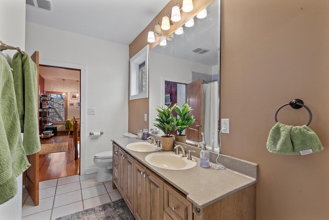 bathroom with tile patterned flooring, a sink, and visible vents