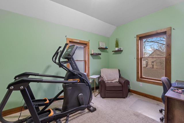 workout room with carpet flooring, vaulted ceiling, and baseboards