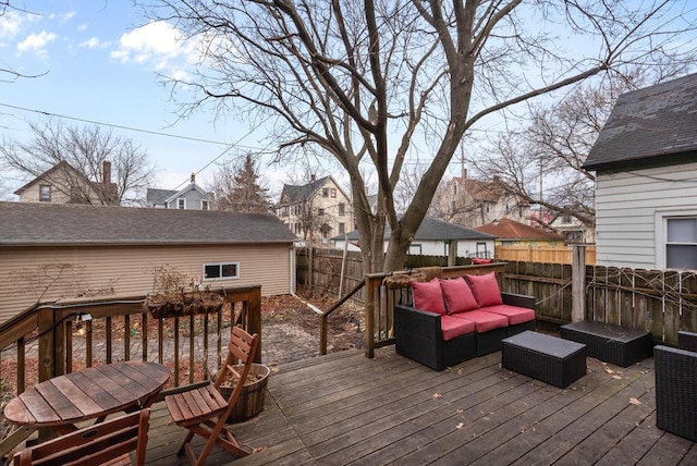 wooden deck featuring an outdoor hangout area and fence