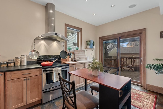 kitchen with recessed lighting, a sink, baseboards, wall chimney range hood, and stainless steel electric stove