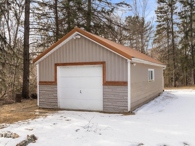 snow covered garage with a garage