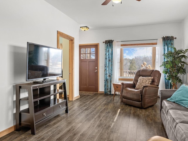 living area with wood finished floors, a ceiling fan, and baseboards