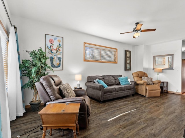 living area with ceiling fan, baseboards, and wood finished floors