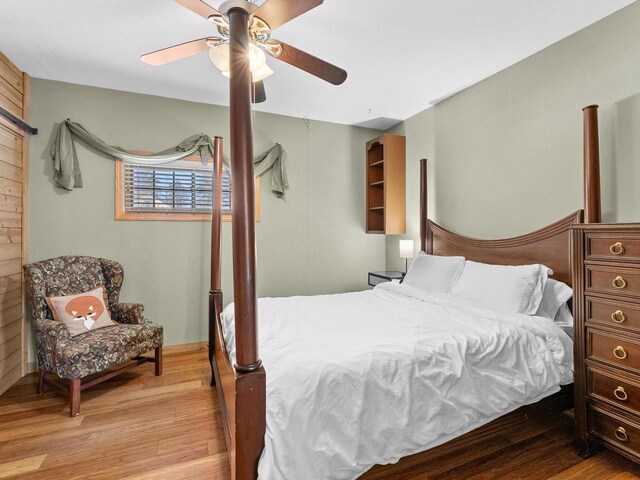 bedroom with light wood-type flooring and ceiling fan