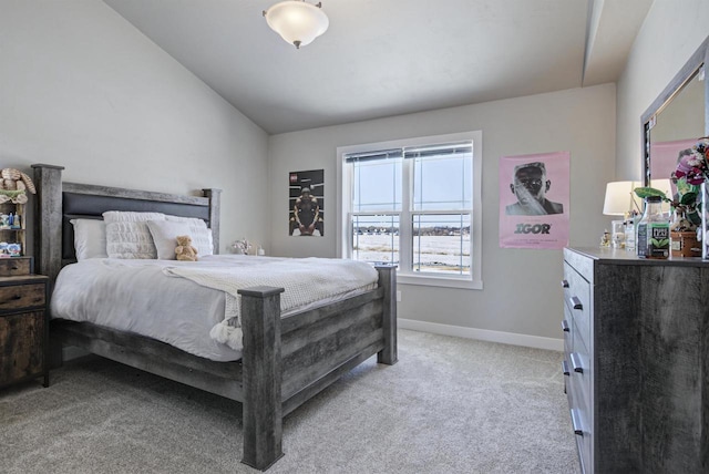 bedroom featuring lofted ceiling, light carpet, and baseboards