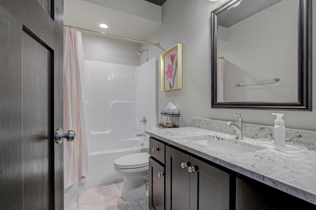 full bathroom featuring toilet, shower / bath combo with shower curtain, and vanity