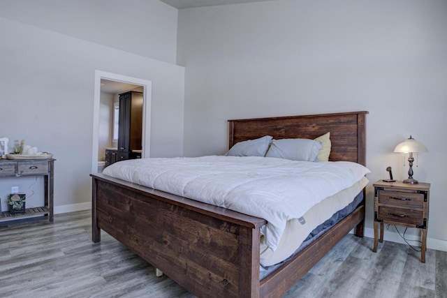 bedroom with light wood-style flooring and baseboards