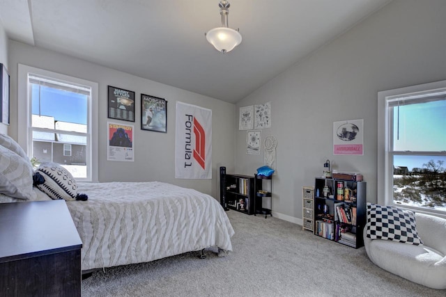 bedroom with lofted ceiling, carpet flooring, and baseboards