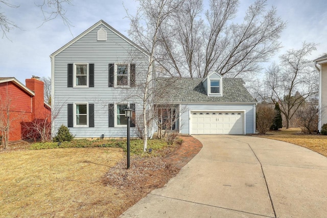 traditional-style home featuring a garage, concrete driveway, a shingled roof, and a front lawn