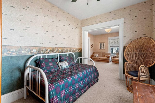 carpeted bedroom with wallpapered walls and ceiling fan