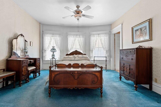 bedroom featuring ceiling fan and carpet