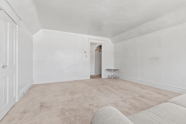 bonus room featuring vaulted ceiling and carpet