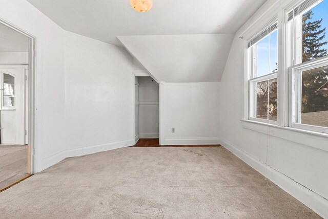 bonus room featuring carpet, vaulted ceiling, and baseboards