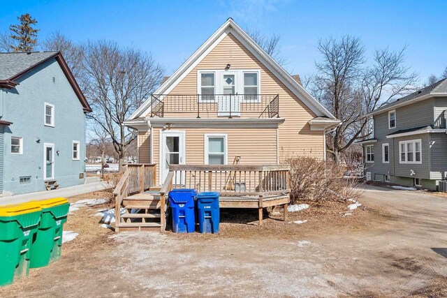 rear view of property featuring a balcony