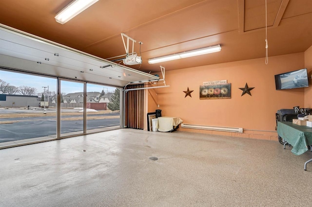 garage featuring baseboard heating and a garage door opener