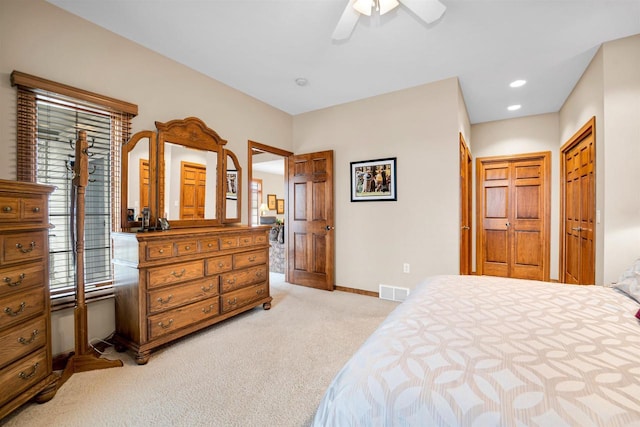 bedroom featuring ceiling fan, recessed lighting, light carpet, visible vents, and baseboards