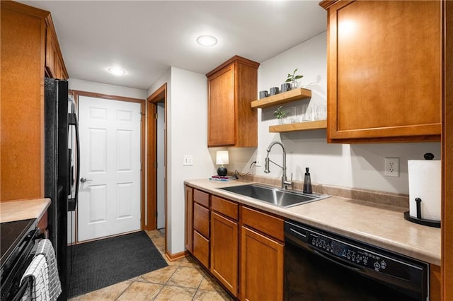 kitchen featuring brown cabinetry, light countertops, black appliances, open shelves, and a sink