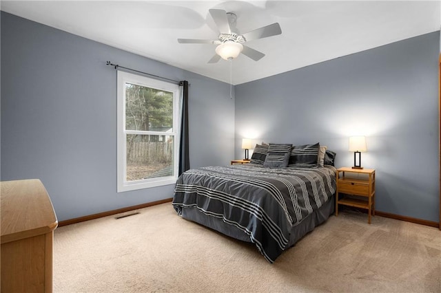 carpeted bedroom with baseboards and a ceiling fan