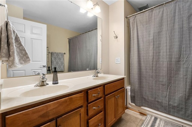 bathroom with double vanity, a sink, and tile patterned floors